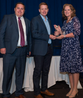 Recipient of a a previous Communication Technology award being presented with their plaque.
