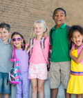 Group of elementary students outside a school.