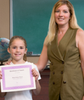 Student being presented with an award by her teacher.