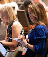 Woman in front of a computer participating in online learning.